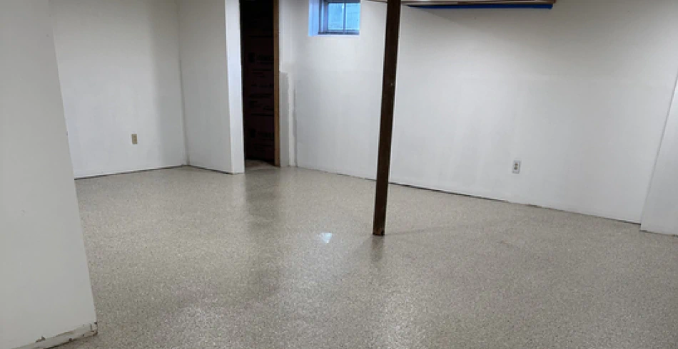 Light flake epoxy floor brightening a finished basement space