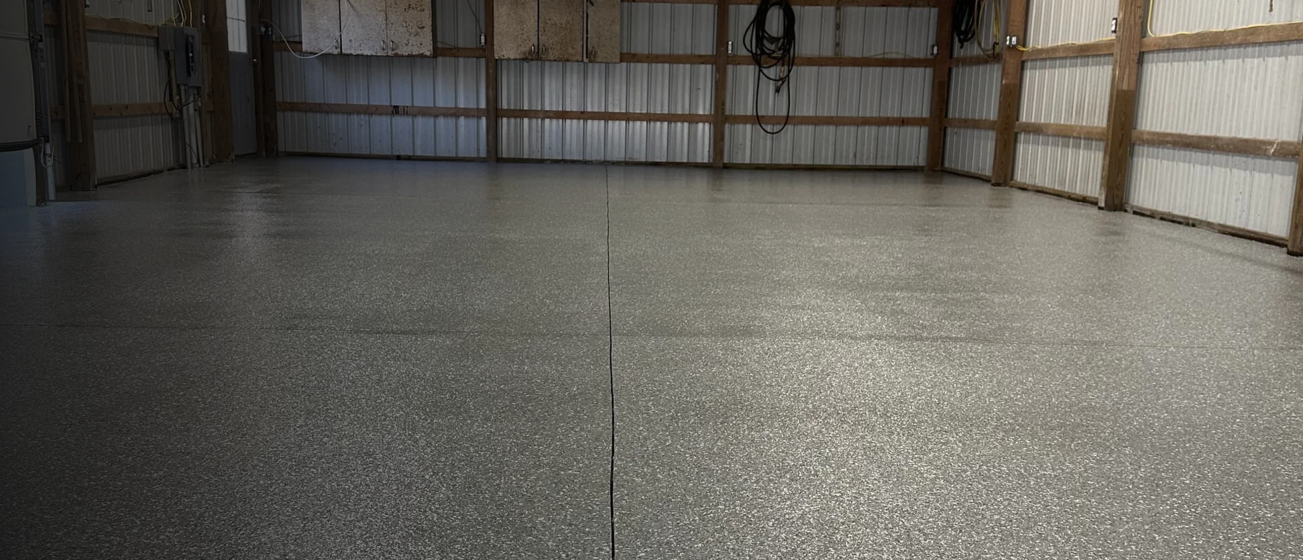 Grey flake epoxy floor finished across a wide garage interior near Boyertown, Pennsylvania