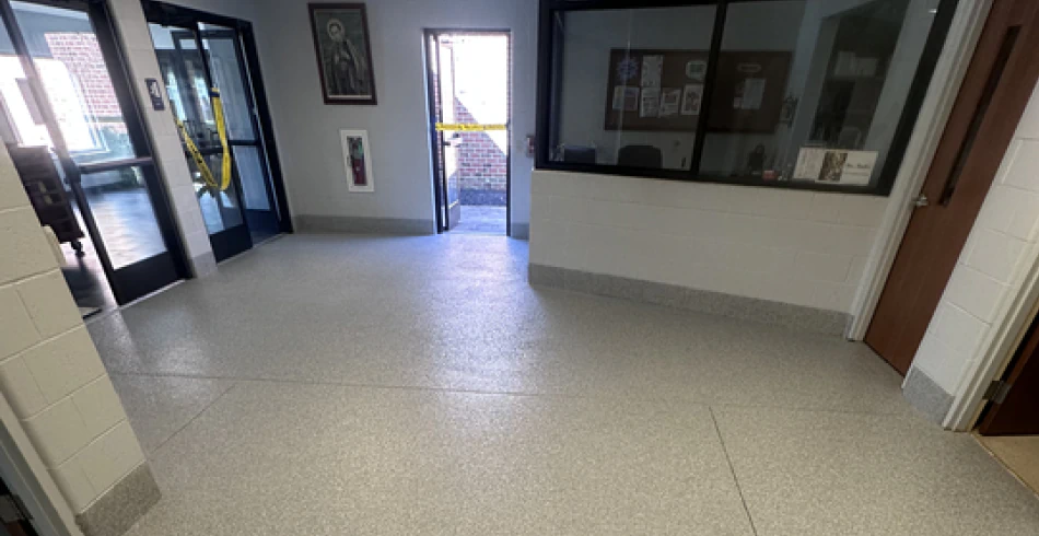 Flake epoxy floor running down a commercial corridor with doors on both sides
